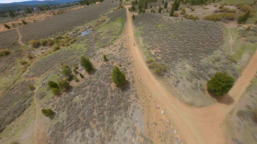 Aerial view of motocross motorcycle driving on a dirth path