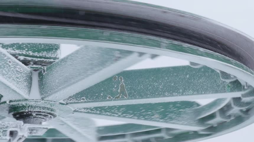 Snow covered wheel spins around