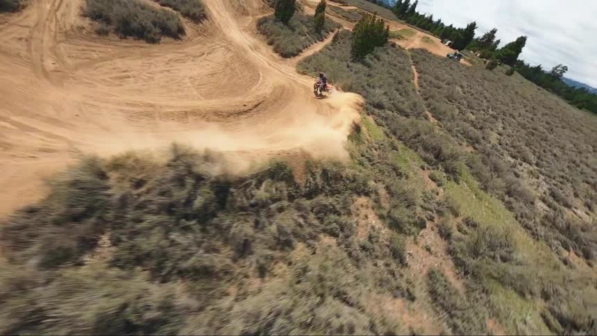Aerial view of a man driving a motorcycle in a motocross track