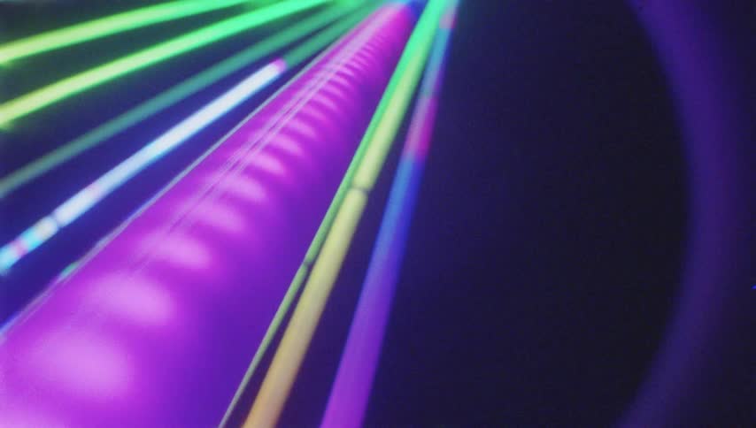 Colorful light cables glow and shine against a dark background