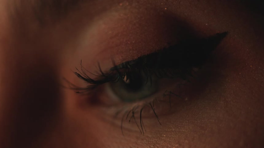 A person with long eye lashes blinks