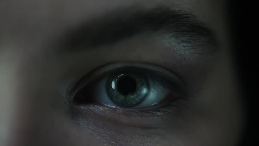 Close up of an eye being scanned with a white beam of light