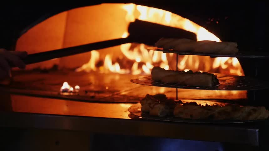 A pizza oven being swept out