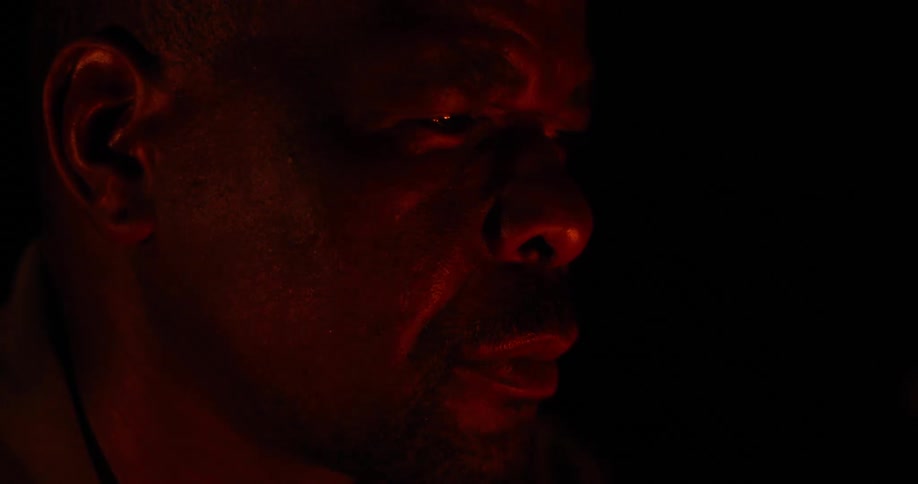 Close up of a man looking at a fire