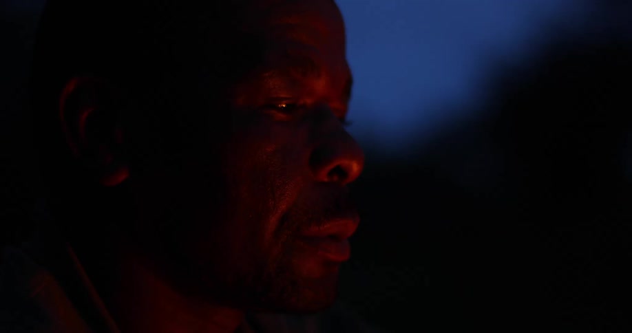 Black man stares straight ahead as he blinks his eyes
