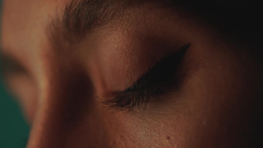 A white woman blinks her eyes