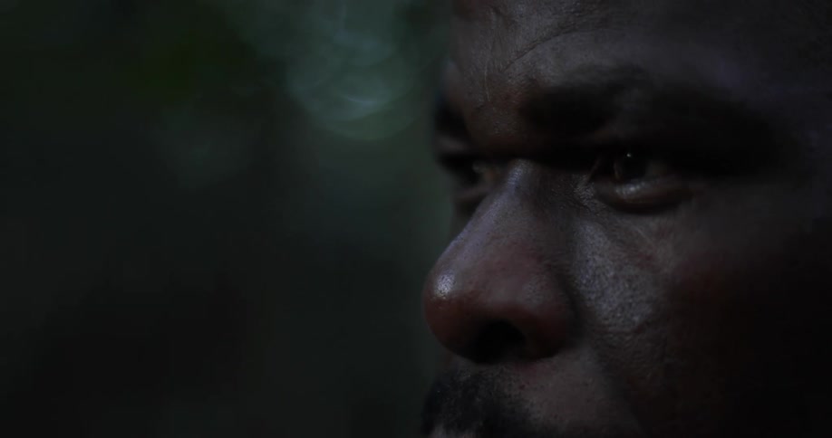 Close up of a mans face outdoors on a dimly lit area