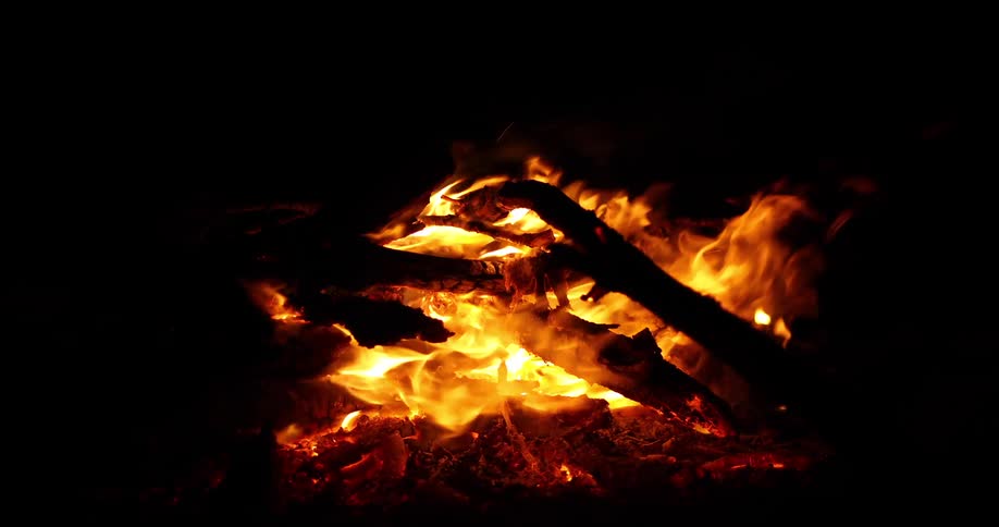 Branches burn in a bon fire at night