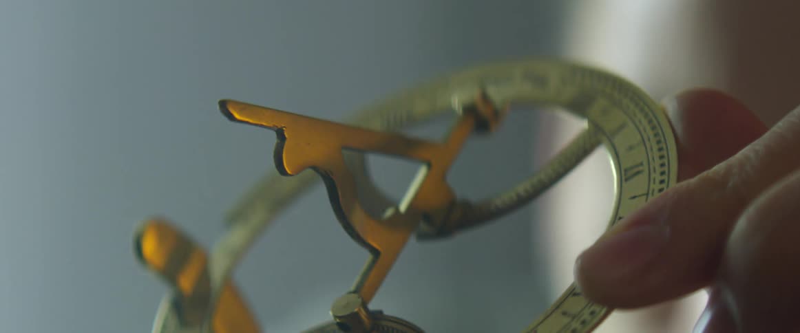 A person turns a tool in their hand