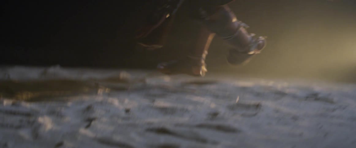 Runner runs and jumps and lands on the ground at night