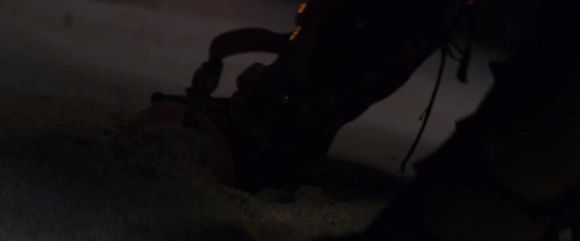 A man digging in the sand