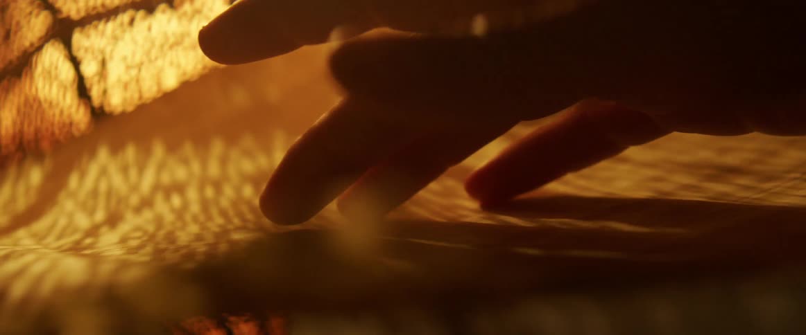 A persons hand gently touching a sheet of paper
