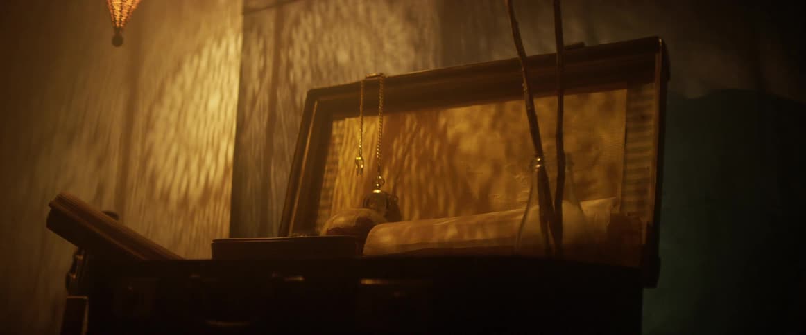 A chest with a chain watch and globe next to a guitar
