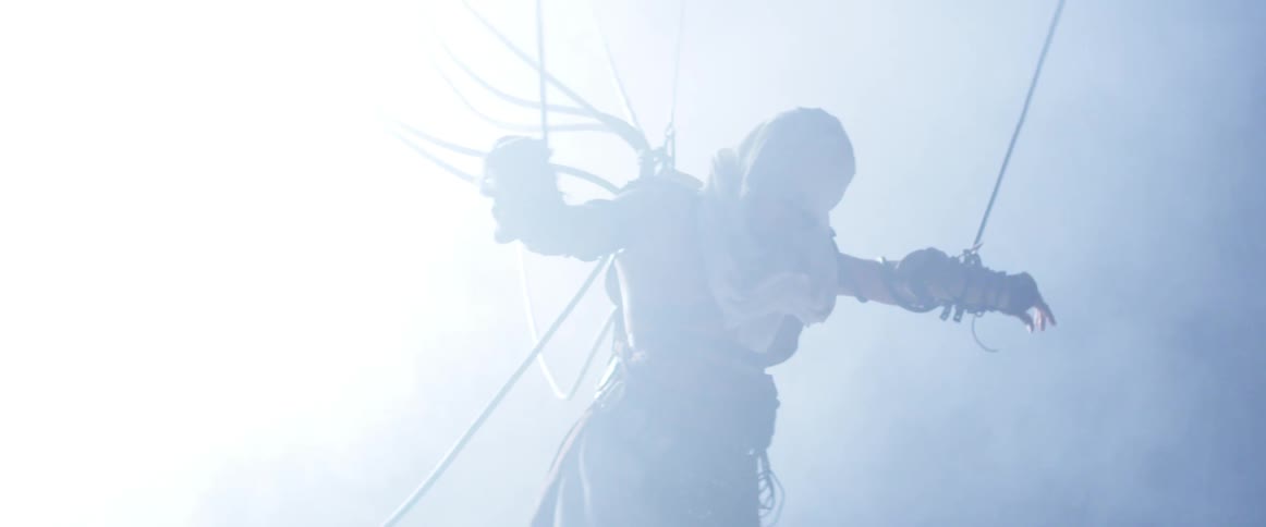 A person is hanging from wires and struggling