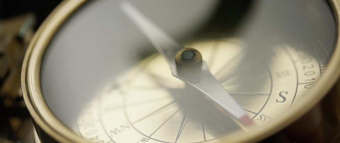 A compass finds direction with a needle pointing to magnetic north