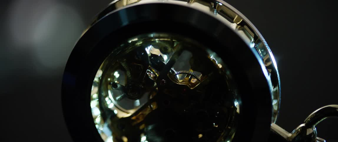 Springs and train of gears running exposed inside a clock