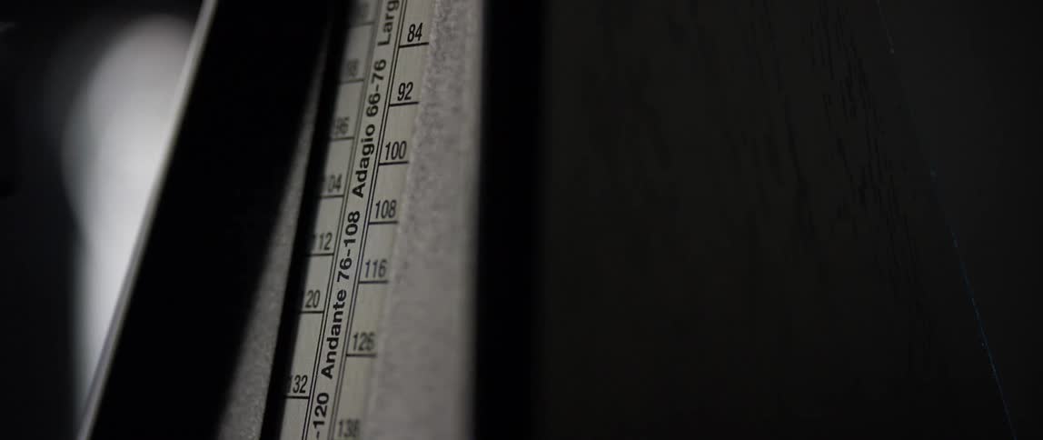 A metronome with the arm moving back and forth