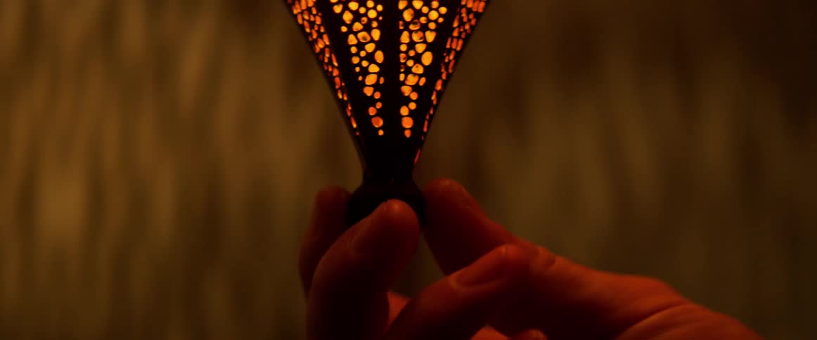 A man touches the bottom of a light