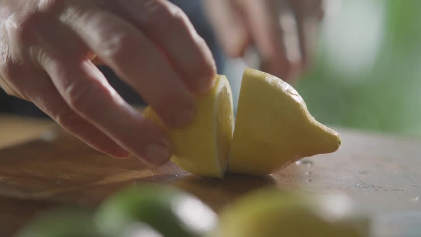 A man cuts a lemon in half