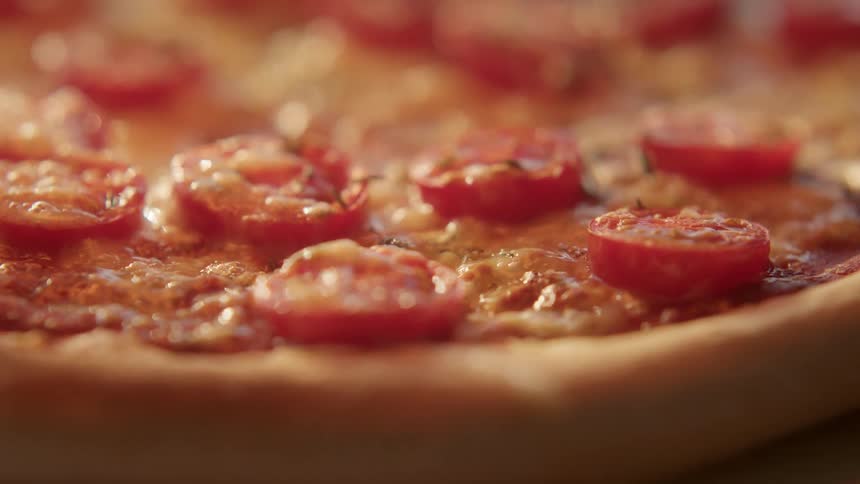 Cheese sizzles on a freshly cooked pizza