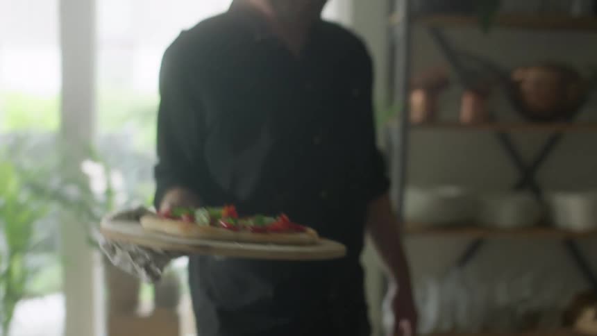 Man prepares homemade pizza in the kitchen