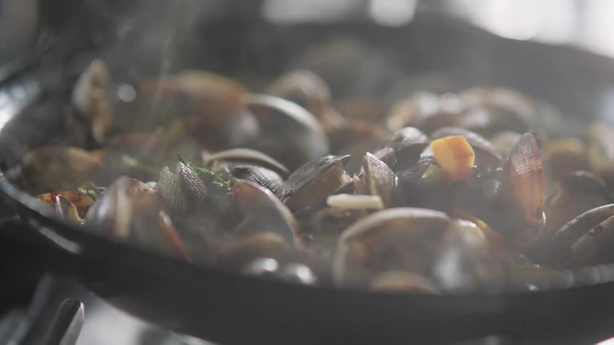Delisious clam meal steaming in a saute pan