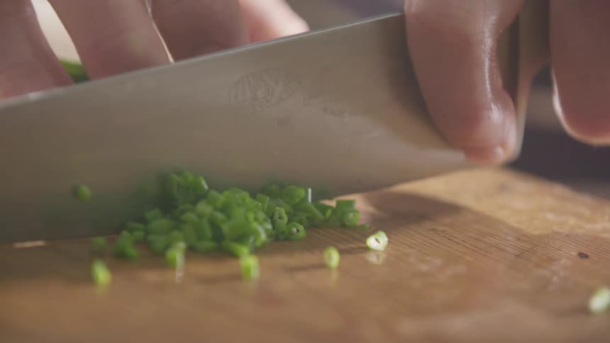 Chopping green onions on cutting board