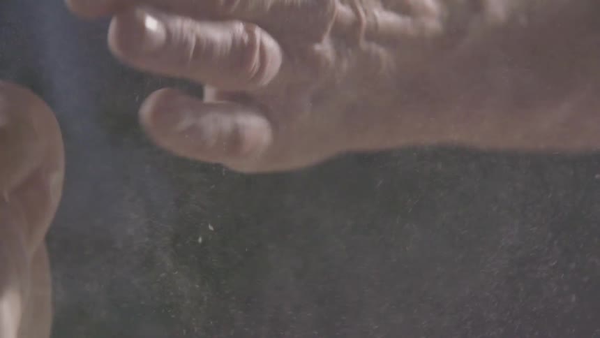A chef rubs his hands together