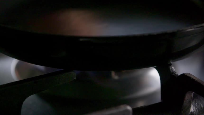 Frying pan over the fire of a stovetop