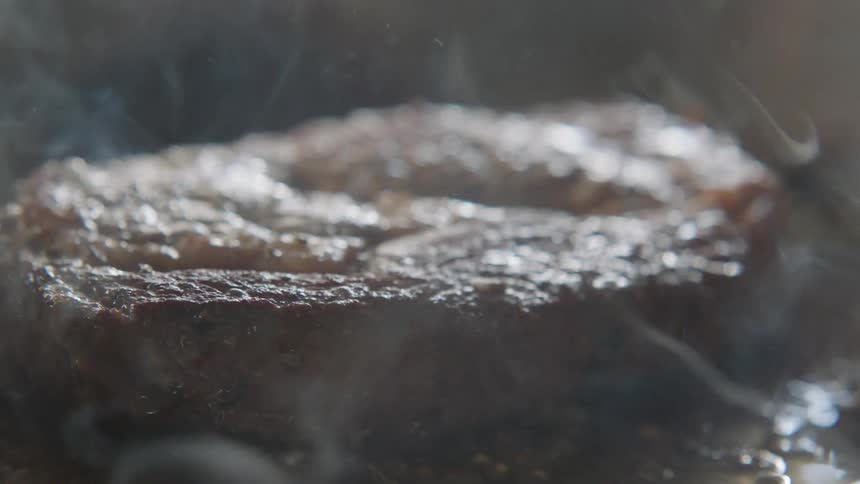 Steak is being cooked on a grill