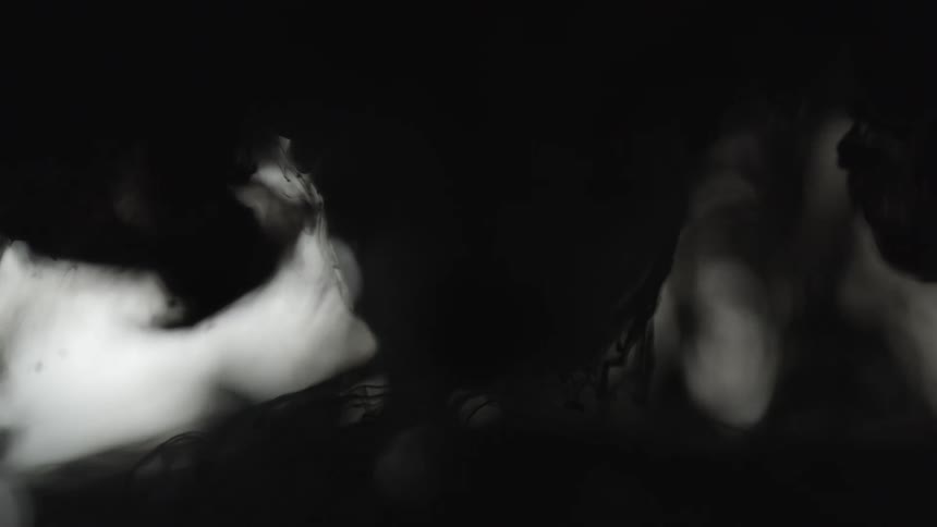 Smoke slowly falling in the distance behind a dark object