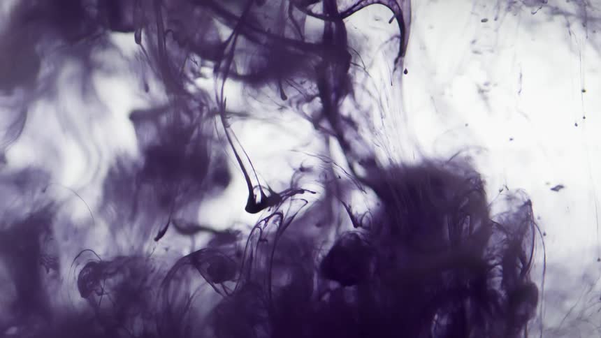 Dark purple black dye sinks into clear liquid