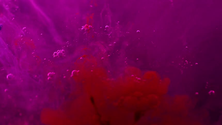 Red liquid swirls into a purple liquid