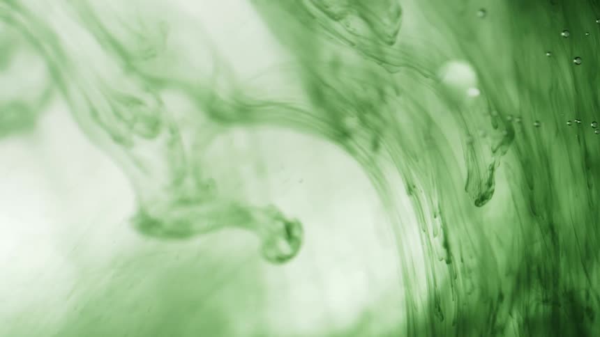 The green color swirls in the liquid
