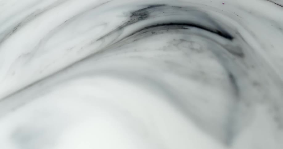 White cloud like shapes swirl with black streaks in them