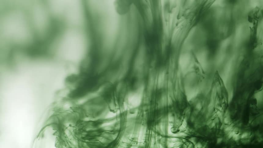 The green ink swirls around in the water