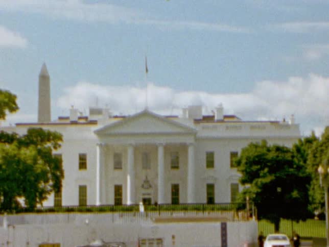 The washington monument is visible behind the white house