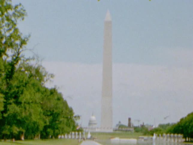 Traffic drives in front of the washington monument