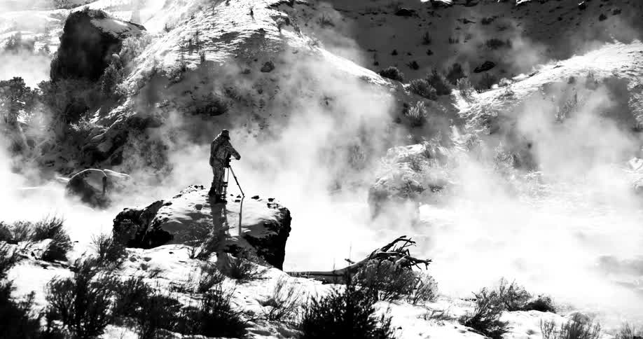 A photographer takes photos of fog over the hills
