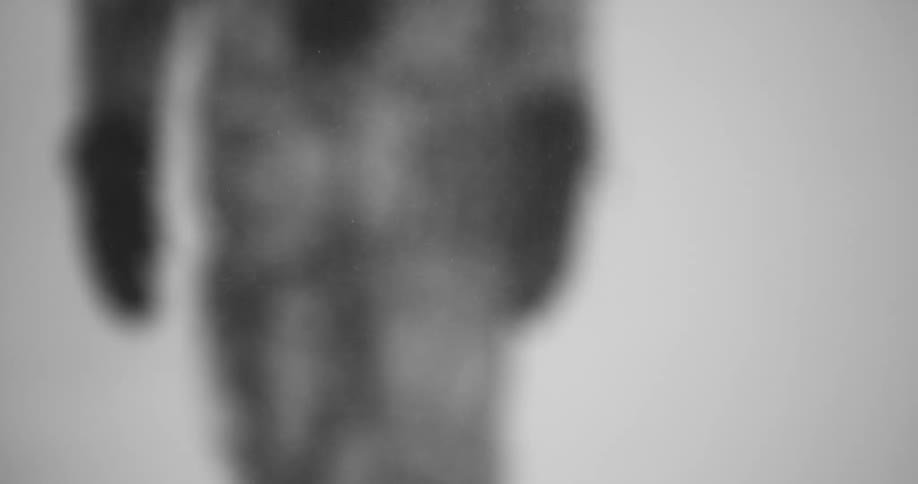 Out of focus figure walks through heavy snowfall