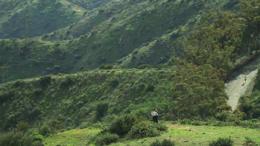 People are hiking and standing on the mountains