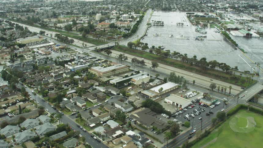 Cars drive on the highway by the town
