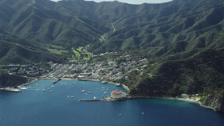 Small port city in a bay between the mountains on an island