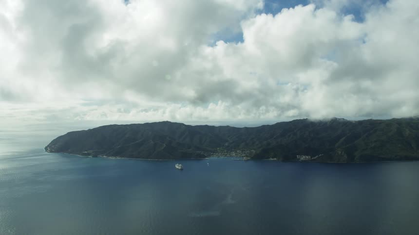 Aerial view of ships around a coastal town in a bay near the ocean