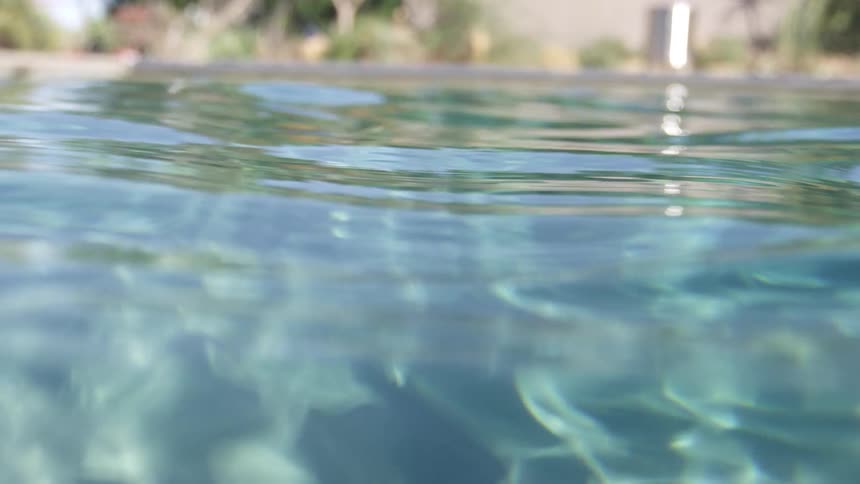 The waves of an outdoor pool on a sunny day