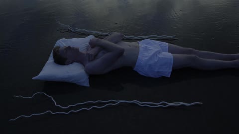 A man sleeping at the beach