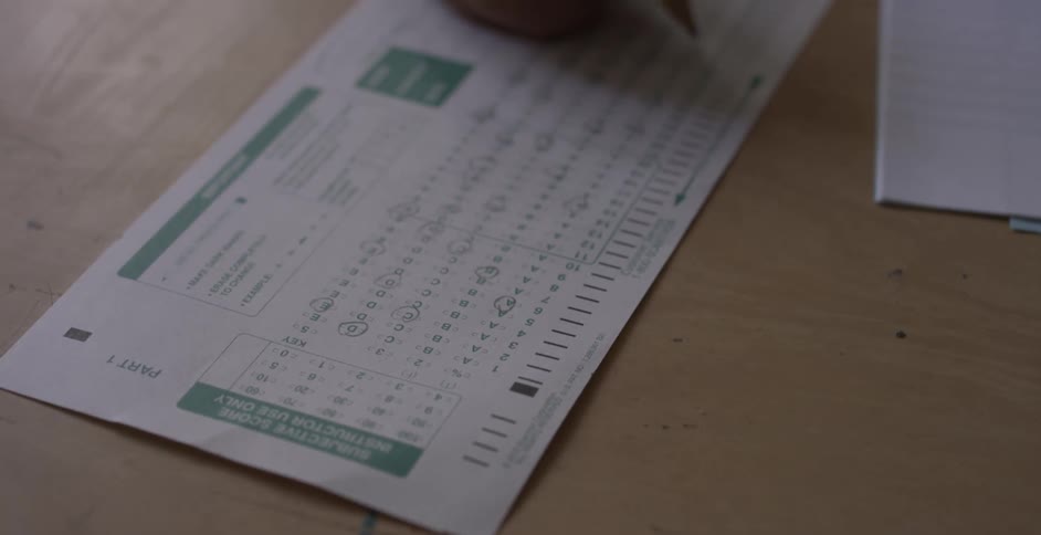 Filling out standardized test sheet with pencil