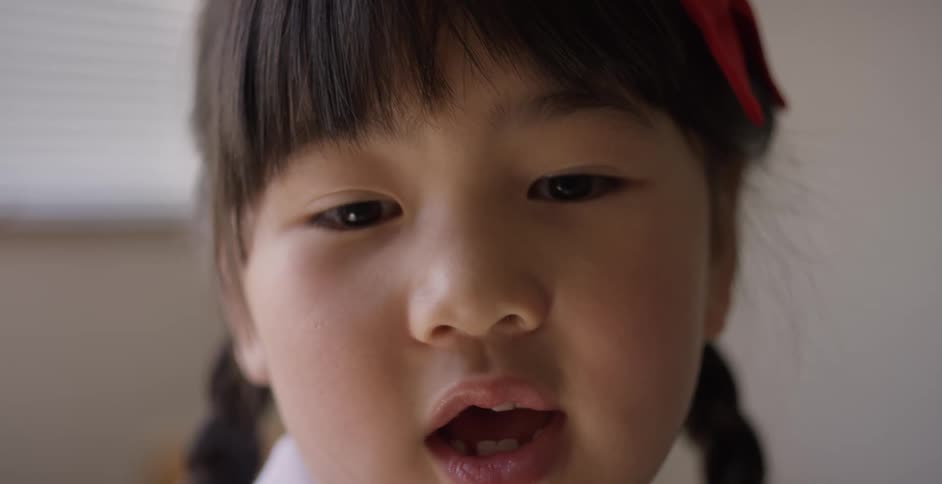 A portrait of a little asian girl talking and smiling