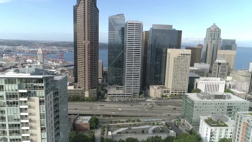 Aerial view of tall buildings and skyscrapers next to the sea