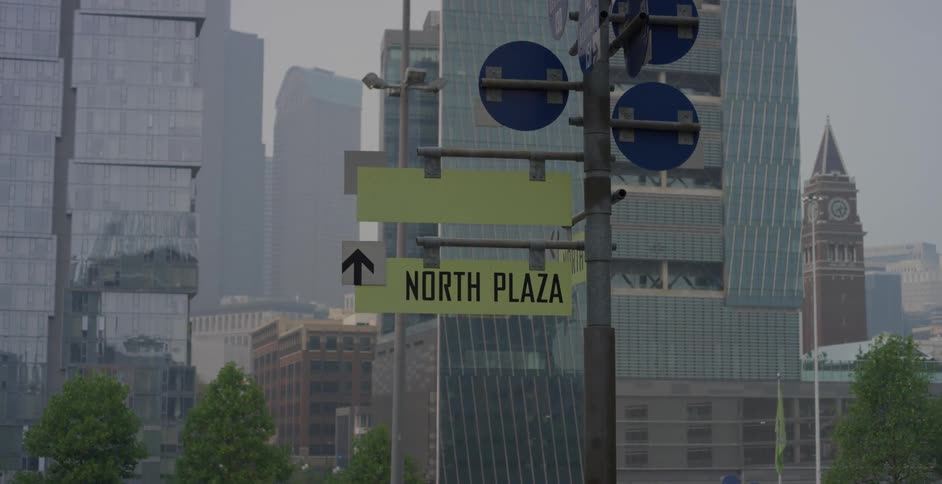 Road sign in front of skyscrapers in the citys downtown area